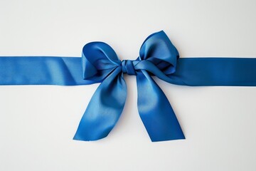 Blue ribbon tied in a bow is laying on a white background