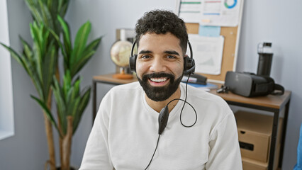 Sticker - Smiling bearded man with headset in modern office portraying a customer service representative.