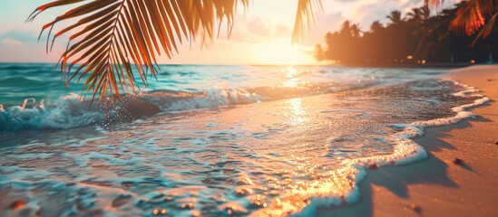 Poster - Sunset on a tropical beach with soft waves and blurred sunlight in the background ideal for a business summer vacation concept with vintage filter style and ample copy space image