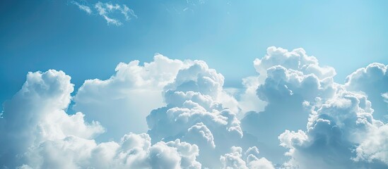 Canvas Print - Fluffy white clouds against a blue sky with plenty of copy space image