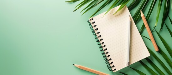 Aufkleber - Minimalistic composition with palm leaves notebook and pencil on a colored background in a flat lay design with a creative idea Includes copy space image