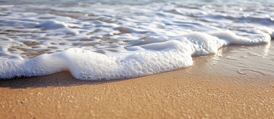 Aufkleber - Sandy beach with white foam in the background Ideal for copy space image
