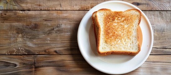 Poster - Place the toasted bread on a white plate over a wooden table with a designated copy space image