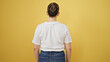 © Krakenimages.com - Young beautiful hispanic woman standing backwards over isolated yellow background