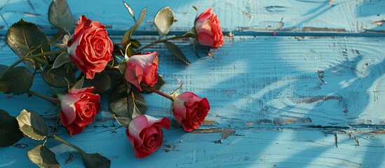 Poster - Vintage style copy space image of roses on a blue wooden surface for adding text