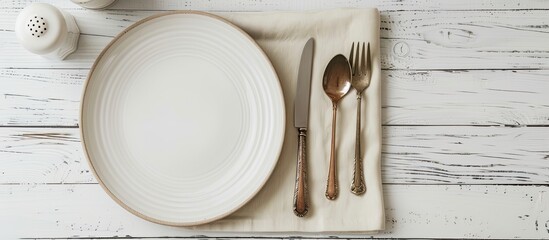 Sticker - A white table with an empty plate and cutlery providing space for additional elements in the image