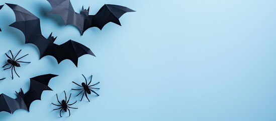 Aufkleber - Halloween themed flat lay with paper bats and spiders on a light blue background featuring copy space for text