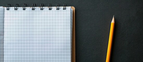 Poster - Copy space image of a notepad and pencil against a dark background