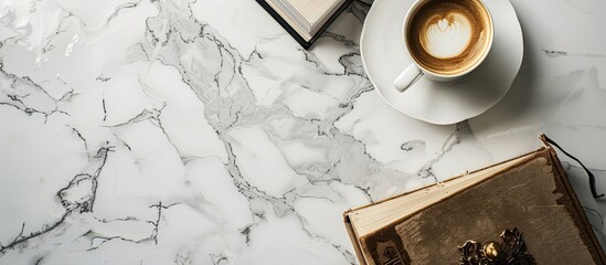 Poster - Top view of a marble table with a coffee cup and books creating a stylish setup with copy space image