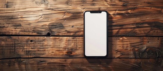 Poster - Place a smartphone with a blank screen on a wooden table providing copy space image