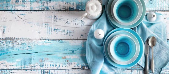 Leinwandbilder - Overhead shot of blue dining set on aged white wood Photo with copy space image