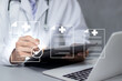 © Ei - A medical worker fills out a business performance document checklist on a laptop. This digital form includes online surveys, questionnaires, and assessment forms.