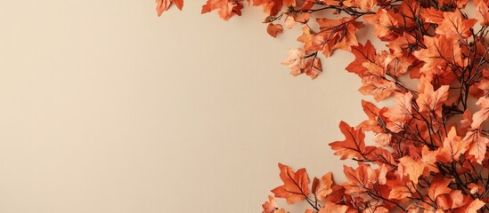 Poster - Autumn arrangement Orange leaves on a beige backdrop with copy space Top view Flat layout Left side