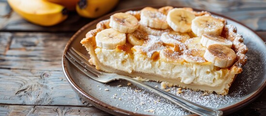 Leinwandbilder - Plate with a slice of delicious banana pie on a wooden surface. with copy space image. Place for adding text or design