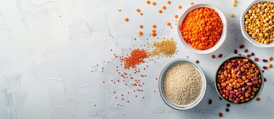 Poster - Assorted legumes lentils chickpeas and beans in various bowls on a white table Top view with copyspace