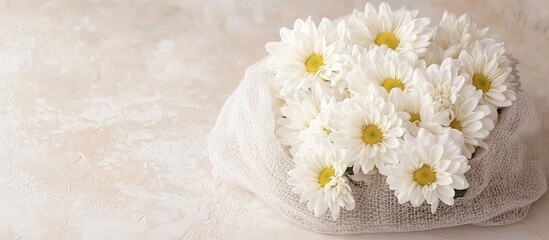 Aufkleber - White chrysanthemum flowers in a cotton mesh bag on a light backdrop Copyspace for your text