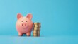 © andri_priyadi - Piggy Bank and Stacked Coins on Blue Background