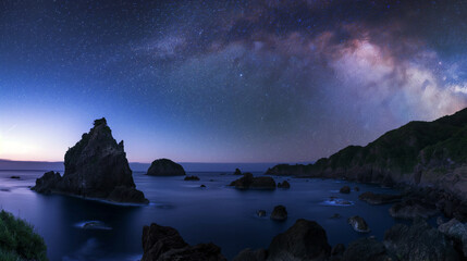 Wall Mural - a beautiful night sky with a large rock in the foreground