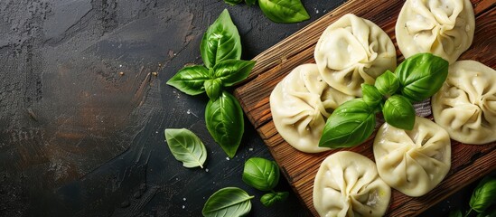 Poster - Wooden board featuring uncooked dumplings and fresh basil with a copy space image