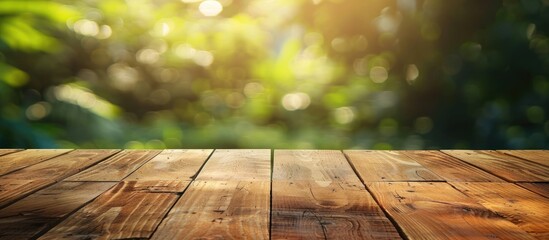 Poster - Wooden table with no items on top placed against a blurred green background providing ample copy space image