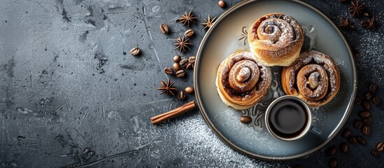 Canvas Print - Plate with cinnamon buns cream and a cup of coffee on a grey grunge background creating an aesthetic display with copy space image