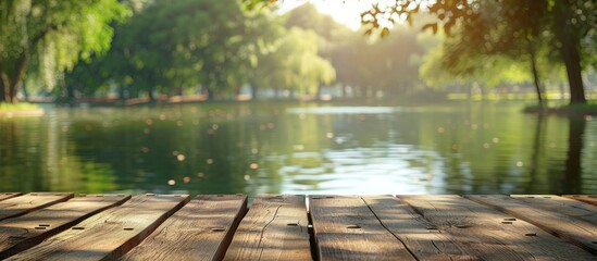 Wall Mural - Wooden table displaying a blur of lake and park scenery in the background forming a serene copy space image to showcase products