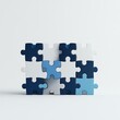 © nunoi - Colorful puzzle pieces interlocked, symbolizing teamwork, problem-solving, and connection against a minimalist background.