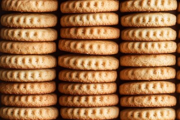 These are freshly baked cookies, stacked and ready to be enjoyed. The close-up shot highlights the texture and the mouth-watering appeal of these delicious treats.