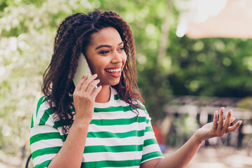 Sticker - Portrait of nice young woman speak phone pastime weekend chill fresh air park outdoors