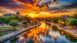 © Man888 - Vibrant sunset casts a warm glow on the historical Pearl of the Concho River, featuring the iconic San Angelo Riverwalk and scenic Texas hills.