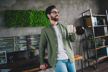 Canvas Print - Portrait of professional hacker young man drink coffee think computer desk loft interior office indoors