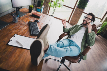 Canvas Print - Full body portrait of professional hacker young man speak telephone computer desk loft interior office indoors