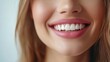 © Iswanto - Close-up of a woman's smile with pink lips and white teeth.