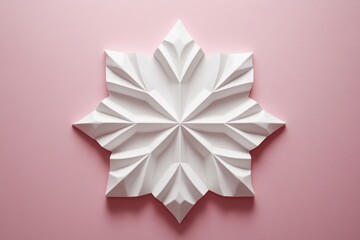 White paper origami flower on pink background