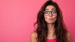 © Iswanto - A young woman with long brown hair, wearing glasses, pouting her lips, looking to the side, against a pink background.