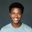 © Vanier Johanne - Cheerful handsome young African man head shot front portrait. Happy positive attractive male entrepreneur, startup leader, business professional in casual looking at camera with toothy smile