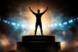 © volga - Silhouette of victorious person on stage with spotlight smoke
