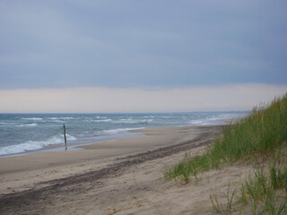 Scenic view of the sea and sand dune on the beach on a gloomy, cloudy weather, Skagen, Denmark