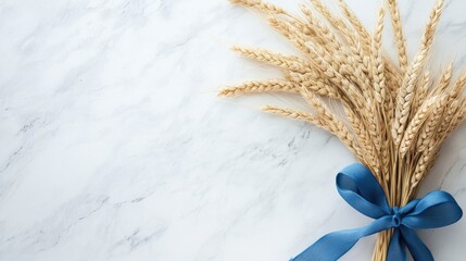 Wall Mural - A simple, charming wheat bouquet with a blue ribbon, resting on a clean white marble surface, perfect for a minimalist theme.