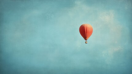 A solitary hot air balloon drifts across a wide-open sky, symbolizing freedom and adventure in an expansive blue canvas.