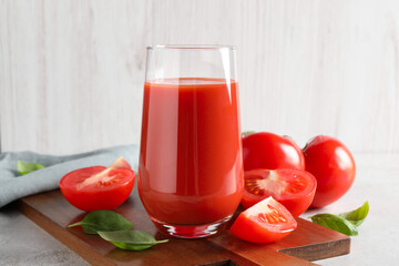 Sticker - Tasty tomato juice in glass, basil leaves and fresh vegetables on light grey table