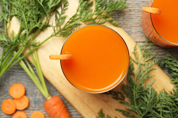 Sticker - Healthy carrot juice in glasses and fresh vegetables on wooden table, top view