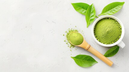 Top view of matcha green tea powder in a white bowl with leaves and a wooden spoon on a light background. Health benefits and antioxidant-rich drink.