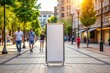 © Natalia - Blank vertical billboard standing on busy pedestrian street with people shopping