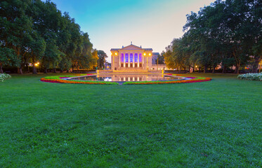 Wall Mural - Fountain in Adam Mickiewicz Park and Poznan Grand Opera during blue hour.