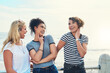 © Frank Coop/peopleimages.com - Laugh, girl and friends by beach for travel adventure, vacation joy or happiness with freedom of youth. Female students, outdoor and together for summer break, holiday and carefree with diversity.