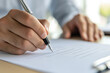 © Kitta Studio - Focused Businessman Writing Important Documents to Make Informed Decisions and Propel His Career Forward in a Professional Setting