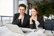 © Viacheslav Yakobchuk - Happy two business partners working with laptop while sitting in restaurant