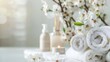 © Wild Dream - White rolled towels and delicate flowers creating a fresh and serene spa ambiance with candles and skincare essentials
