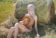 © Andrey_Arkusha - Sexy young woman in a straw hat lies on a haystack